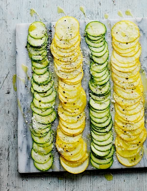 Photograph of a platter of zucchini, courgette, carpaccio lined up in rows