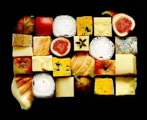 Photograph of cubes of cheeses, apples and figs