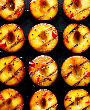 Photograph of grilled peaches lined up