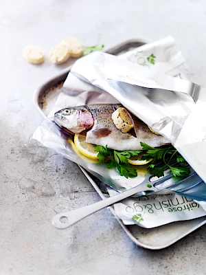 Waitrose Service Counter Poster. Photograph of uncooked whole fish on a baking tray with herb butter, lemon and parsley