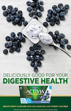 Advert for Digestive Health Blueberry Yogurt. Photograph of blueberry petal shapes surrounding a yogurt pot with spoon of yogurt