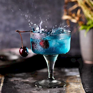Photograph of a Black Cherry Cocktail with a big splash