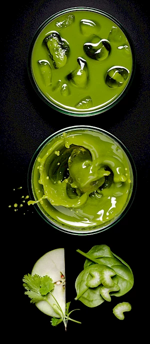 Photograph of apple and spinach juice with splash