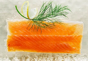 Maple smoked salmon on slab of ice with dill and lemon